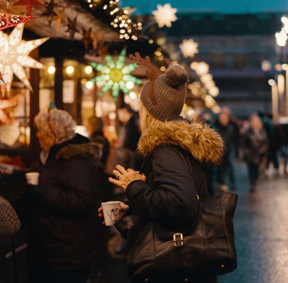 People drinking coffee at Christmas markets